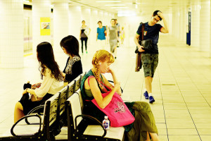 People sitting on bench in a subway station