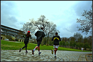 Three people jogging away from camera