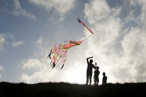 Three children flying a kite