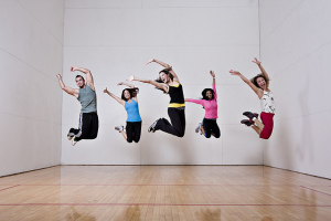 Five people all in the same mid-air jumping pose