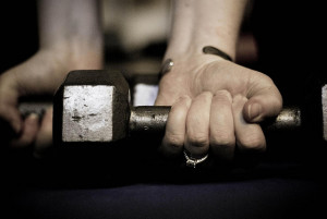 Hand lifting dumbbell