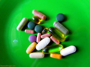 Various vitamins on a green background