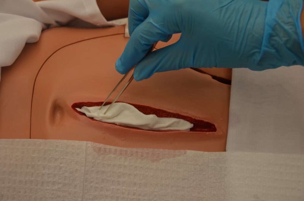 Photo showing packing of simulated wound