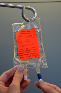 Removing sterile blue cap from IV bag