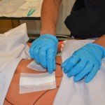 Removing outer dressing with non-sterile gloves