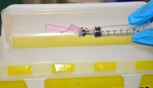 Disposing syringe in sharps container
