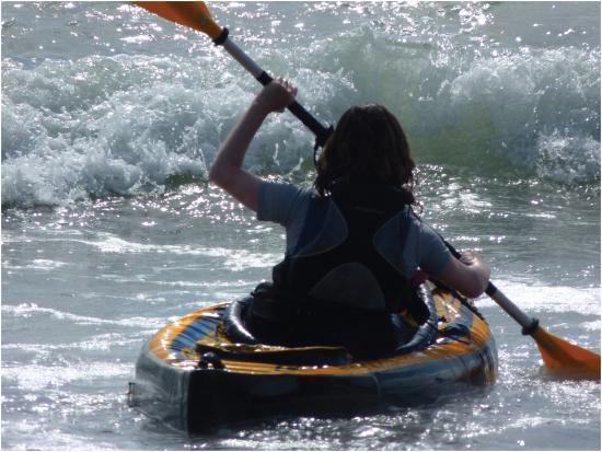 Posterior view of person kayaking